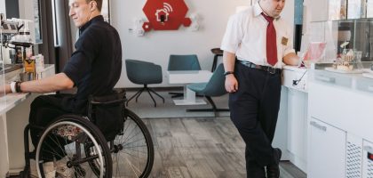 Two male employees working in an inclusive office setting, showcasing accessibility and diversity.